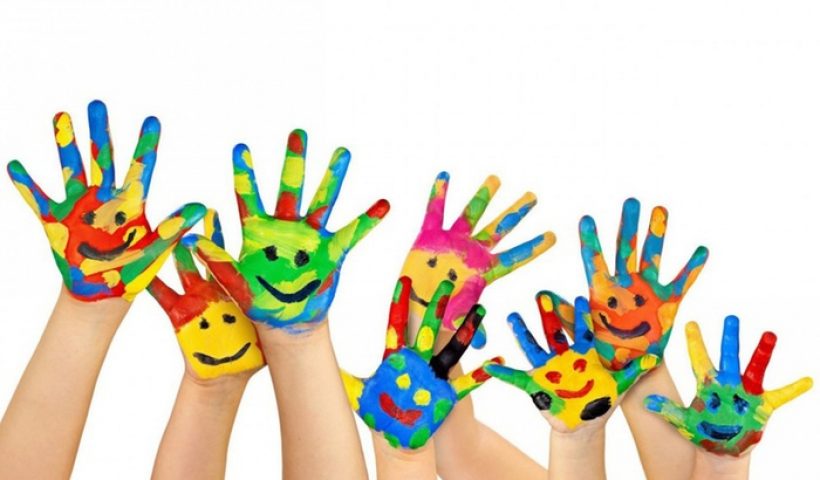 Painted hands of kids raised in the air